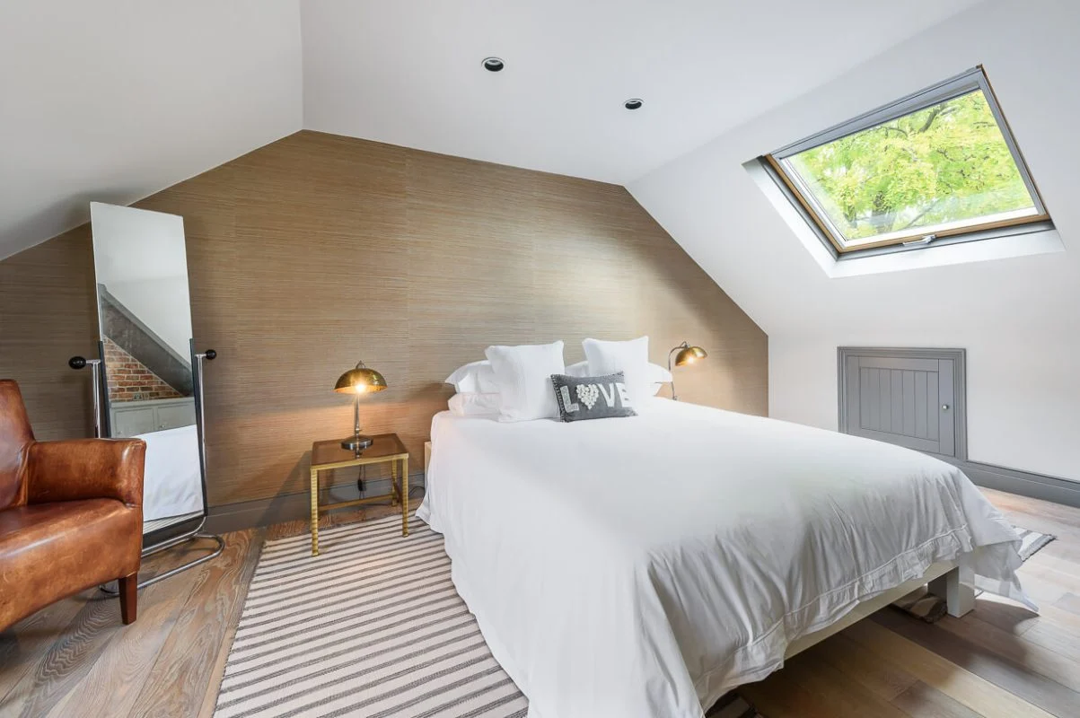 Loft conversion bedroom by AXE Construction, loft conversion specialists across South West London