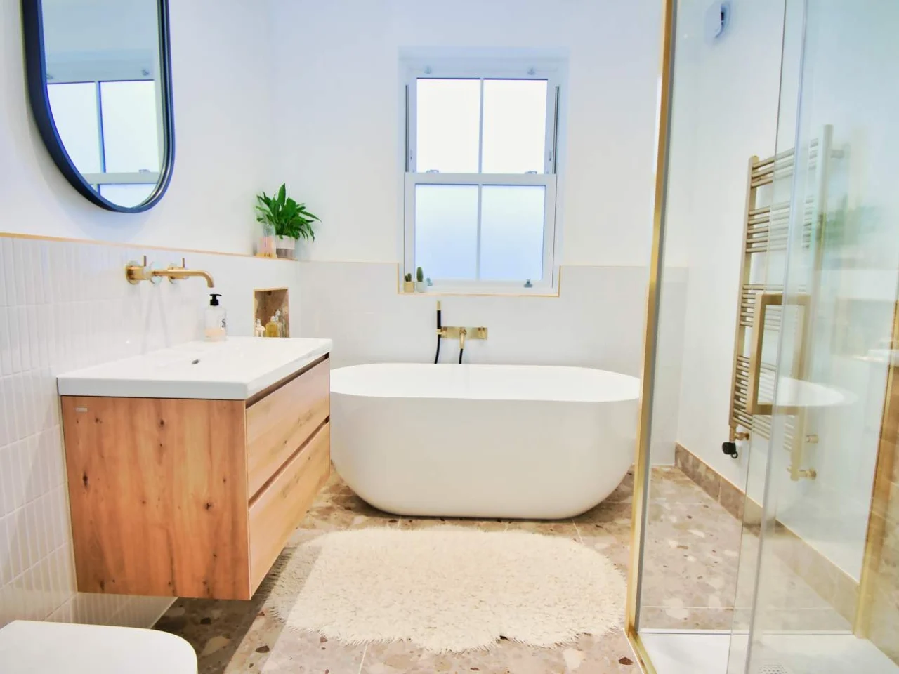 Refitted family bathroom with a curved-edge bath