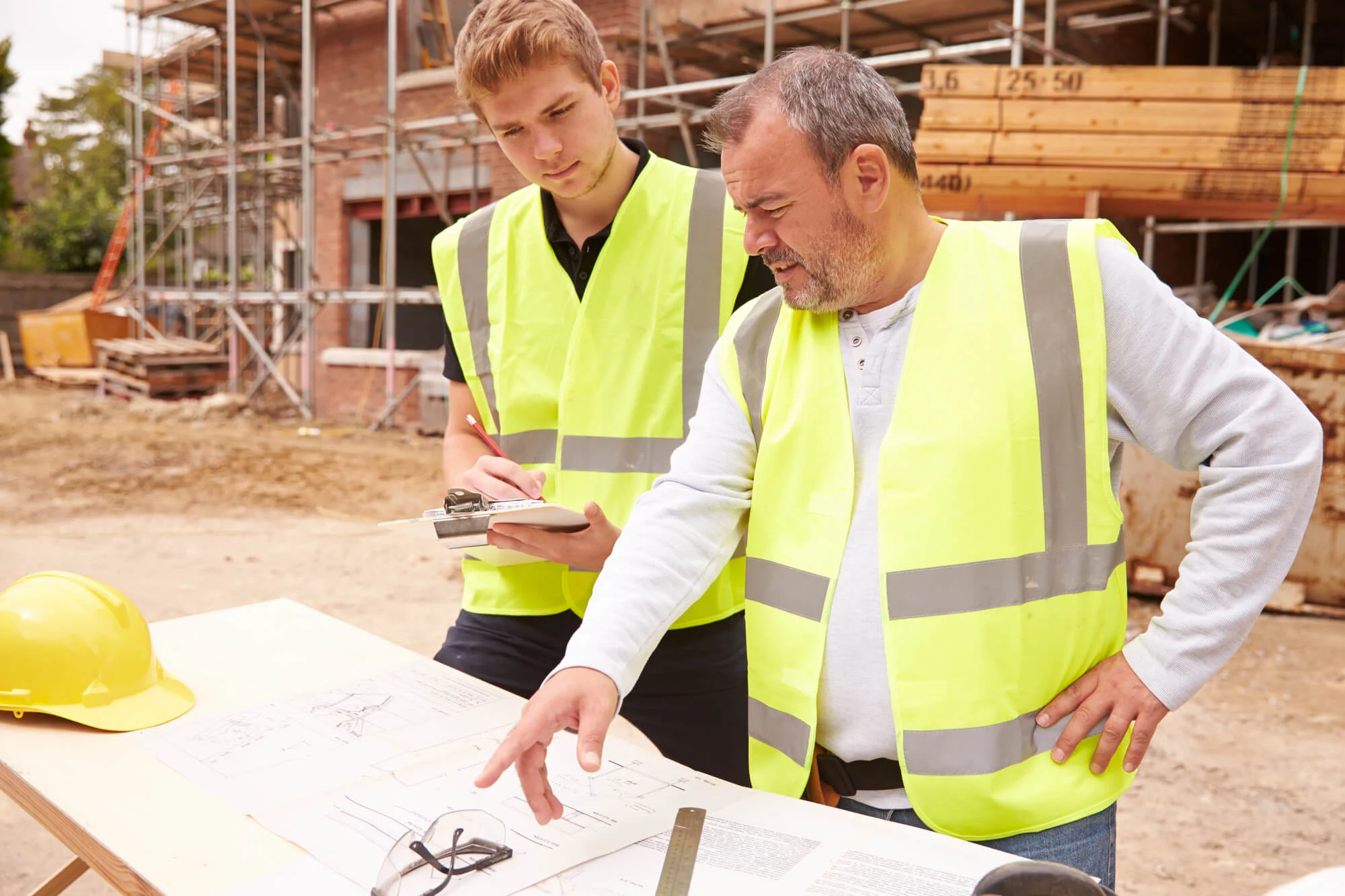 Homeowner and site manager going through drawings together