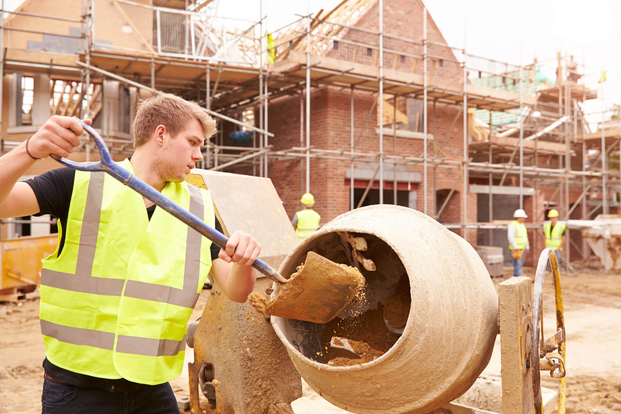 Builder fitting structural timber during a loft conversion