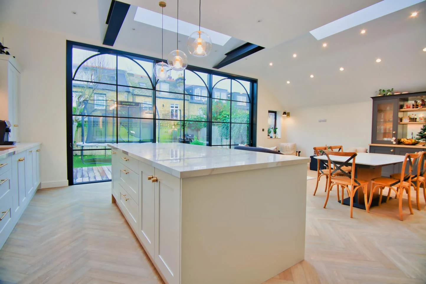Kitchen island facing bi-fold doors onto the garden