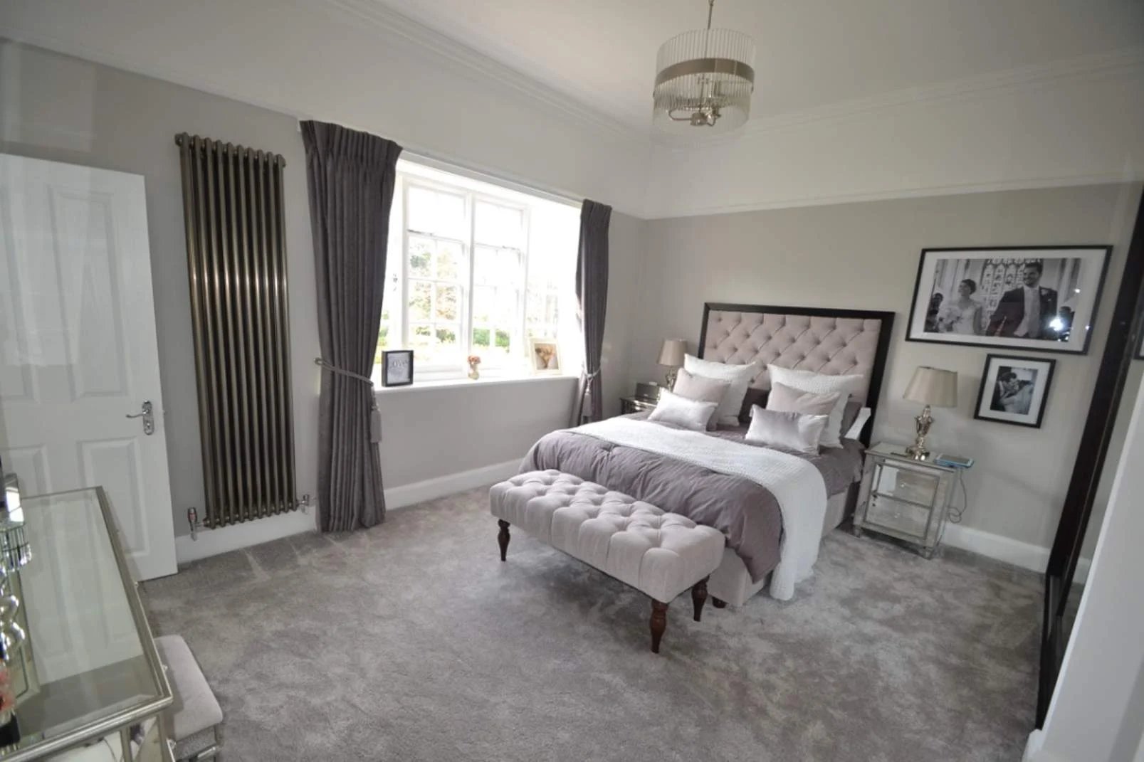 Modern grey master bedroom after renovation