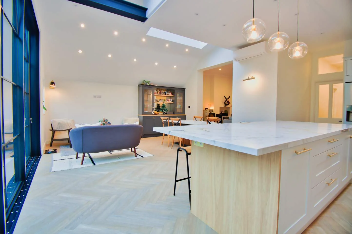 Open-plan kitchen, island and living space in a rear extension