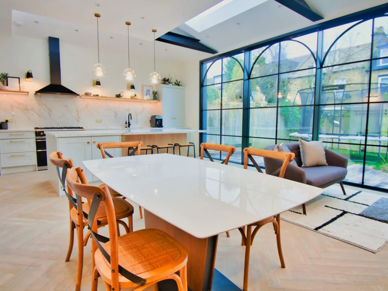 Open-plan kitchen and living room with bi-fold doors to the garden