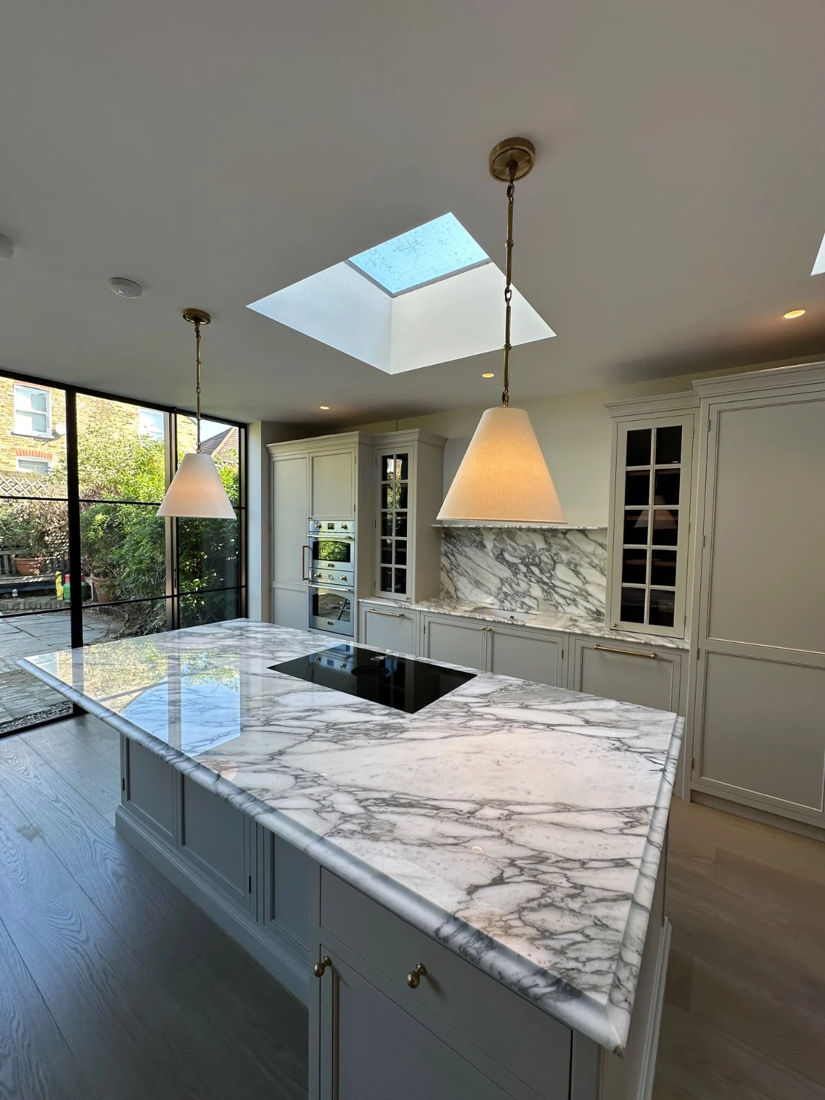A premium-tier kitchen install in a side return extension — the kitchen alone typically accounts for £13K–£18K of a £65K project.
