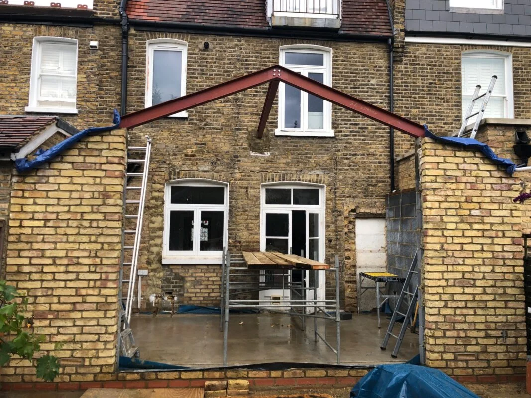 Mid-build reality — structural steel installation and party wall management are where most of the cost surprises in extension projects emerge.